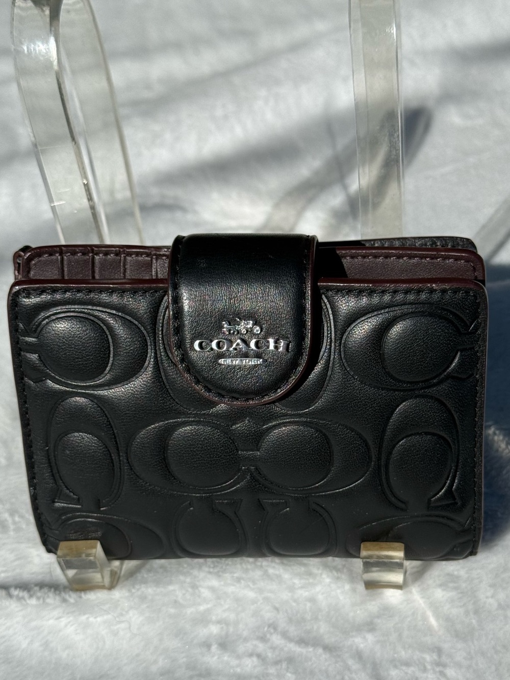 Coach Medium Corner Zip Wallet crafted in black embossed signature leather